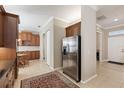 Open kitchen features stainless steel refrigerator and wood cabinets at 1625 Lancashire Dr, Venice, FL 34293