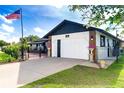 Charming home featuring a manicured lawn, a modern two-car garage, and a welcoming entrance at 23 Tiffany St, Englewood, FL 34223