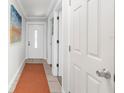 Bright hallway featuring neutral walls, tile flooring, and white doors with decorative trim at 2311 Eugene St, Sarasota, FL 34231
