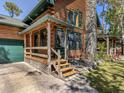 Close-up of the beautiful log home featuring a charming front porch at 2450 Flagami Ln, North Port, FL 34286