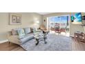 Comfortable living room features a water view, sliding glass doors leading to a sun room and coastal decor at 250 Santa Maria St # 216, Venice, FL 34285