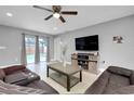 Bright living area with tile floors, a sectional sofa, and sliding glass doors to the pool area at 4068 Palau Dr, Sarasota, FL 34241