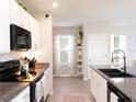 Modern kitchen featuring granite countertops, white cabinets, stainless steel appliances, and contemporary fixtures at 4907 Wedgeleaf Way, Palmetto, FL 34221