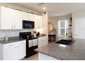 Bright kitchen features white cabinets, granite countertops, and stainless steel appliances at 4907 Wedgeleaf Way, Palmetto, FL 34221