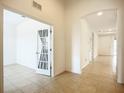 Long hallway with light tile floors, high ceilings and plenty of light at 5384 Layton Dr, Venice, FL 34293