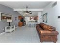 Bright, open-concept living space with tile floors seamlessly connecting to the modern kitchen at 8132 Coco Solo Ave, North Port, FL 34287