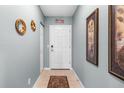 Inviting entryway with tile flooring, decorative wall art, and a secure front door at 8405 Placida Rd # 206, Placida, FL 33946