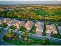 Birds-eye view of a home showcasing its red tile roof, manicured lawn, and proximity to the community at 27336 Driver Ln, Englewood, FL 34223