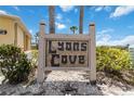 The Lyons Cove sign surrounded by lush green landscaping and a building at 101 Louella Ln # 11, Nokomis, FL 34275