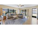 Comfortable living room featuring natural light and neutral décor for a cozy ambiance at 11153 Deerwood Ave, Englewood, FL 34224
