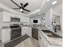 Modern kitchen featuring stainless steel appliances, granite countertops, and white cabinets at 1232 Pine Needle Rd, Venice, FL 34285