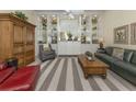 A beautifully decorated living room with recessed lighting, built-in shelves, and elegant furniture at 13166 Huerta St, Venice, FL 34293