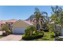 Attractive single-story home with a two-car garage, well-maintained landscaping, and a paved brick driveway at 13415 Coluccio St, Venice, FL 34293
