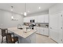 Modern kitchen featuring stainless steel appliances, granite countertops, and stylish pendant lighting at 1608 Saddlewood Cir, Port Charlotte, FL 33953
