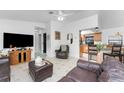 Bright living room showcasing tile floors, comfortable leather furniture, and an open-concept design at 1609 Kirkwood St, North Port, FL 34288