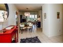Open-concept dining area flows seamlessly into the living room, featuring contemporary lighting and tiled floors at 1711 Gondola Park Dr # 1711, Venice, FL 34292