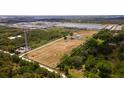 Large land featuring a home, pond, and boat, all framed by a white boundary line at 1727 E Manasota Beach Rd, Englewood, FL 34223