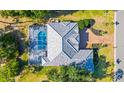 Aerial view of property with screened in pool, patio, well manicured lawn, and distinct roof design at 2187 Calusa Lakes Blvd, Nokomis, FL 34275