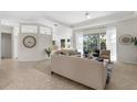 Open-concept living room with neutral tones, abundant natural light, and comfortable seating arrangement at 2187 Calusa Lakes Blvd, Nokomis, FL 34275