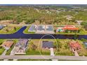 An aerial view of a residential property with water access and surrounding houses in a tranquil, scenic location at 233 Rotonda Cir, Rotonda West, FL 33947