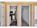 Condo entryway with sightlines to a kitchen with stainless steel appliances and a hallway with storage at 2405 N Beach Rd # 4, Englewood, FL 34223