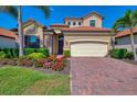 Stunning single Gathering home with beautiful landscaping, a brick paved driveway and 2 car garage at 24193 Gallberry Dr, Venice, FL 34293