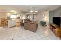 Spacious living room with an open layout, ceramic floors, and seamless flow into the adjacent kitchen at 3167 Night Heron Ln, Venice, FL 34293