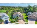 Stunning aerial view of home showcasing landscaping, golf course and serene pond at 3337 Pine Shadow Cir, North Port, FL 34287