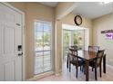 Cozy breakfast nook featuring a bay window, tile floors, and a wooden table set for four at 414 Laurel Lake Dr # 203, Venice, FL 34292