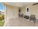 Covered patio area featuring a private entrance and convenient storage at 423 Pirates Pt, North Port, FL 34287
