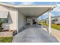 Spacious carport area with room for vehicles and outdoor grilling, with a pond view at 425 Pirates Pt, North Port, FL 34287