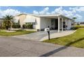 Quaint single-story home with a convenient carport and well-maintained front lawn at 425 Pirates Pt, North Port, FL 34287