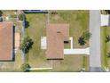Aerial view showcasing a well-maintained home with a spacious backyard and neat landscaping at 511 Porpoise Rd, Venice, FL 34293