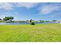 Expansive green backyard overlooking the water offering peaceful views at 553 Circlewood Dr # T11, Venice, FL 34293