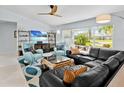 Bright and airy living room featuring comfortable seating, stylish decor, and large windows at 608 Apalachicola Rd, Venice, FL 34285