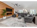 Comfortable living room boasts a wood accent wall and a plush gray sectional at 616 Gardenia Dr, Venice, FL 34285