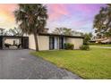 Inviting home showcasing lush landscaping, mature palm trees, and a relaxing screened-in lanai at 633 White Pine Tree Rd # 27, Venice, FL 34285