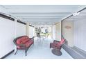 Relaxing screened-in lanai furnished with comfortable seating and ambient string lights at 633 White Pine Tree Rd # 27, Venice, FL 34285