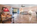 Comfortable living room with neutral walls, ceiling fan, and glass sliding doors to lanai offering natural light at 6724 Schooner Bay Cir # 6724, Sarasota, FL 34231