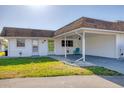 Charming home features a light exterior, covered parking and well maintained lawn and landscape at 680 Circlewood Dr # W3, Venice, FL 34293