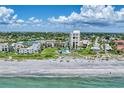 Luxury beachfront condos featuring a community pool and lush landscaping with direct beach access at 700 Golden Beach Blvd # 115, Venice, FL 34285