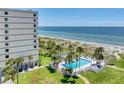 Enjoy a sparkling community pool steps from the beach, with palm trees and ocean views at 700 Golden Beach Blvd # 115, Venice, FL 34285