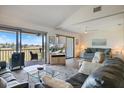 Bright living room with vaulted ceilings and sliding glass doors to the screened lanai with great golf course views at 726 Bird Bay W Dr # 153, Venice, FL 34285