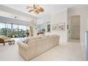 Open living room boasts sliding doors to screened patio and backyard water views at 744 Fringed Orchid Trl, Venice, FL 34293