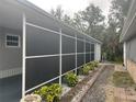 Enclosed back porch with screens providing a cozy and private outdoor living space at 795 Cervina N Dr, Venice, FL 34285