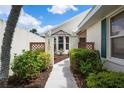 Inviting walkway leading to the front door with lush greenery and decorative features at 799 Harrington Lake N Dr # 73, Venice, FL 34293