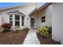 Warm and inviting front entrance with a bay window, well-kept landscaping, and a charming pathway at 799 Harrington Lake N Dr # 73, Venice, FL 34293