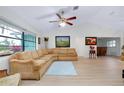 Inviting living room with vaulted ceilings, light wood floors, and a comfortable sectional sofa at 990 Sea Fox Rd, Venice, FL 34293