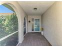 Welcoming screened-in front porch with tiled floors, providing a cozy and sheltered entry to the home at 1004 Deer Run, Venice, FL 34293
