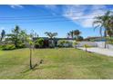 Well-manicured lawn and modern home with unique wood accents for a beautiful curb appeal at 106 Playmore Dr, Venice, FL 34293